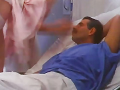 A guy alongside a suit talking round nurses